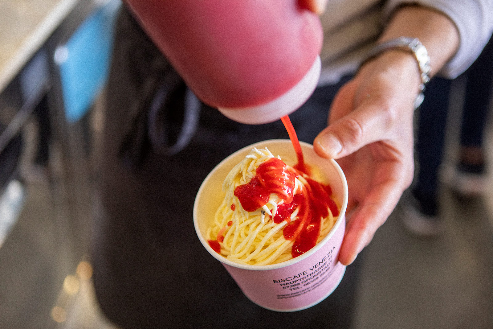 De Zordo Eiscafé Grünstadt Mitarbeiter macht Erdbeersoße auf Spaghetti Eis